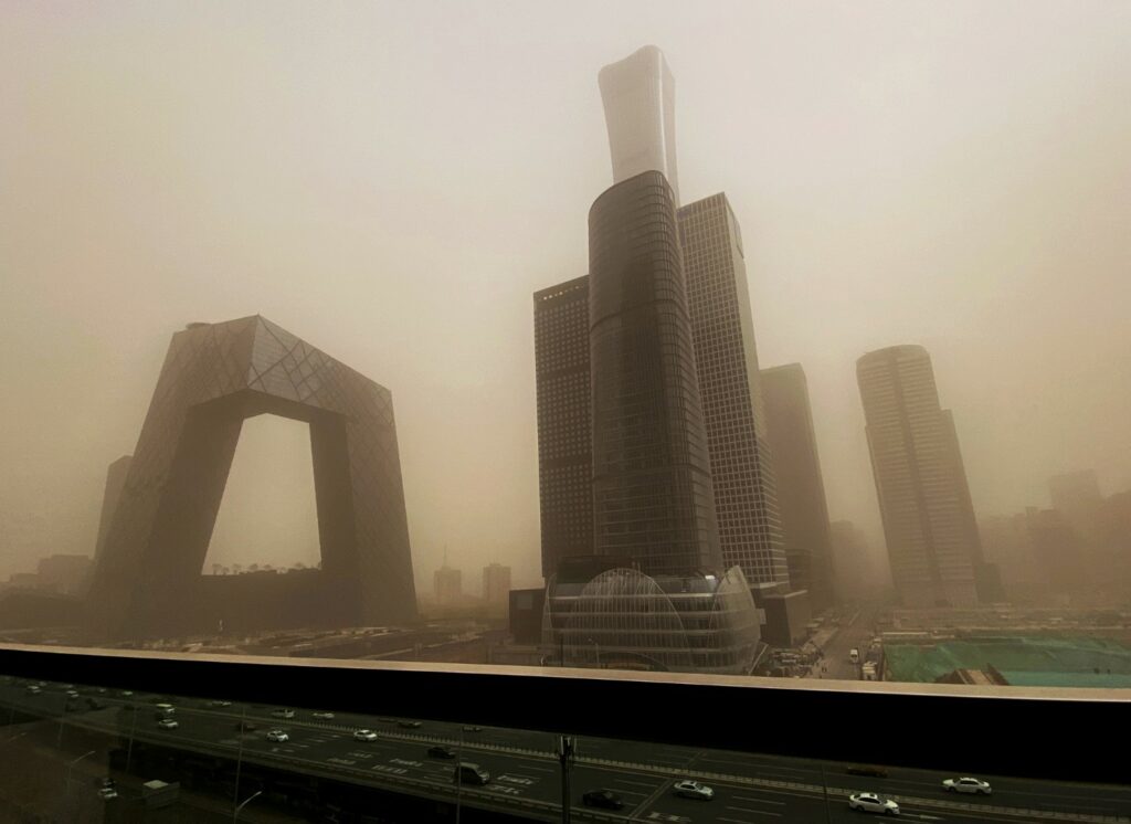 BEIJING, CHINA - MARCH 15: The CCTV building and the Central Business District is seen shrouded in air pollution during a sandstorm on March 15, 2021 in Beijing,