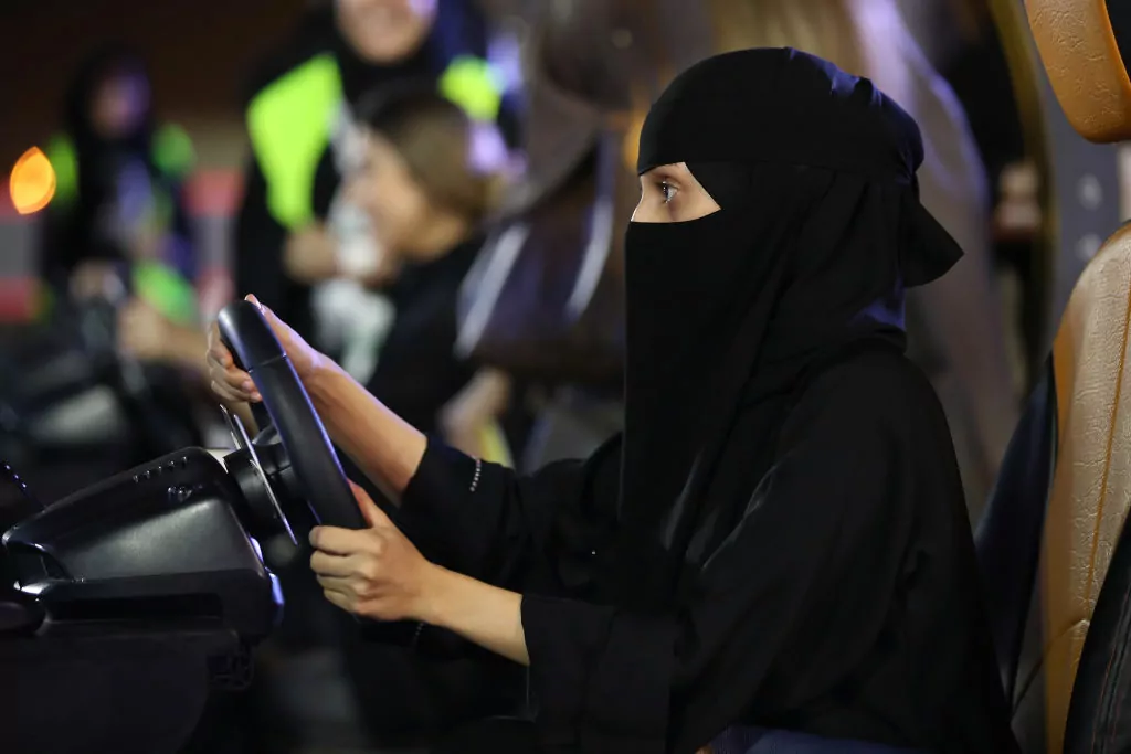 JEDDAH, SAUDI ARABIA - JUNE 21: A young woman who is wearing a traditional Muslim niqab tries out a car driving simulator during an outdoor educational driving event for women on June 21, 2018 in Jeddah, Saudi Arabia. Saudi Arabia is scheduled to lift its ban on women driving, which has been in place since 1957, on June 24. The Saudi government, under Crown Prince Mohammad Bin Salman, is phasing in an ongoing series of reforms to both diversify the Saudi economy and to liberalize its society. The reforms also seek to empower women by restoring them basic legal rights, allowing them increasing independence and encouraging their participation in the workforce. Saudi Arabia is among the most conservative countries in the world and women have traditionally had much fewer rights than men. (Photo by Sean Gallup/Getty Images)