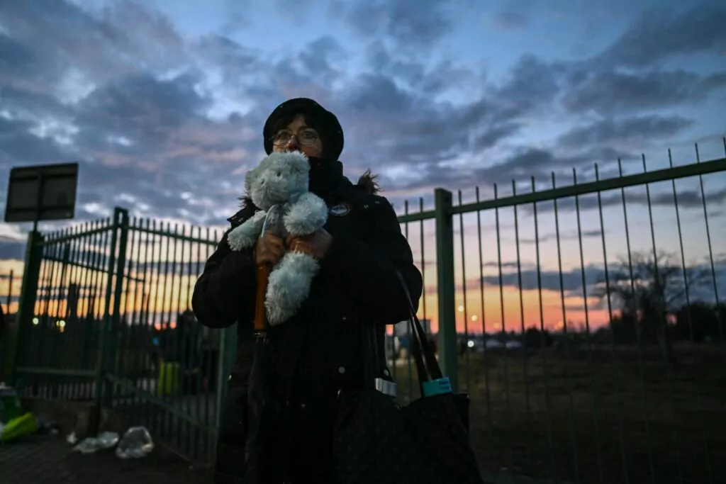 MEDYKA, POLAND - FEBRUARY 25: An Ukrainian woman holds a teddy bear used as sign to welcome an unknown refugee that will cross the Polish Ukrainian border on February 25, 2022 in Medyka, Poland. The Ukrainian government issued order to stop 18-60 year-old men legible for military conscription from crossing borders. On February 24, 2022 Russia began a large-scale attack on Ukraine, with Russian troops invading the country from the north, east and south, accompanied by air strikes and shelling. The Ukrainian president said that at least 137 Ukrainian soldiers were killed by the end of the first day. (Photo by Omar Marques/Getty Images)