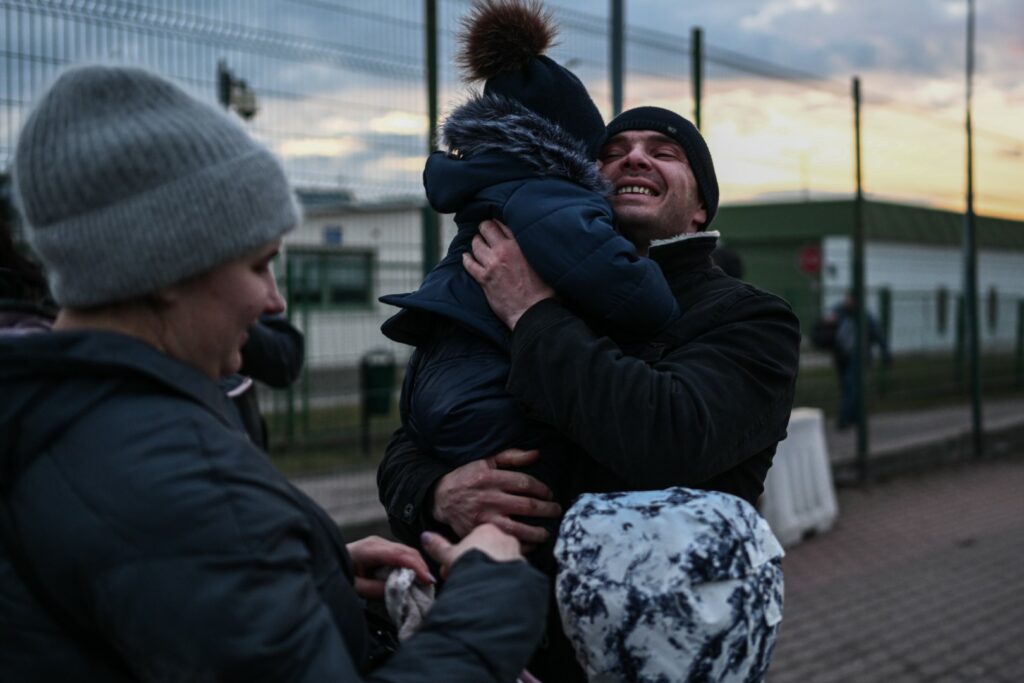 MEDYKA, POLAND - FEBRUARY 25: An Ukrainian man hugs his son who crossed the Polish Ukrainian border with his mother on February 25, 2022 in Medyka, Poland. The Ukrainian government issued order to stop 18-60 year-old men legible for military conscription from crossing borders. On February 24, 2022 Russia began a large-scale attack on Ukraine, with Russian troops invading the country from the north, east and south, accompanied by air strikes and shelling. The Ukrainian president said that at least 137 Ukrainian soldiers were killed by the end of the first day. (Photo by Omar Marques/Getty Images)