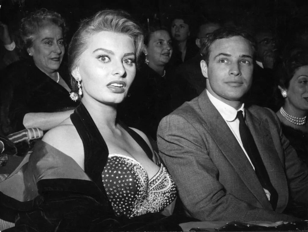 11th November 1954: Italian actress Sophia Loren and US actor Marlon Brando at a cinema in Rome, where Brando received the Francesco Pasinetti Prize for his performance in the film 'On The Waterfront'. (Photo by Keystone/Getty Images)