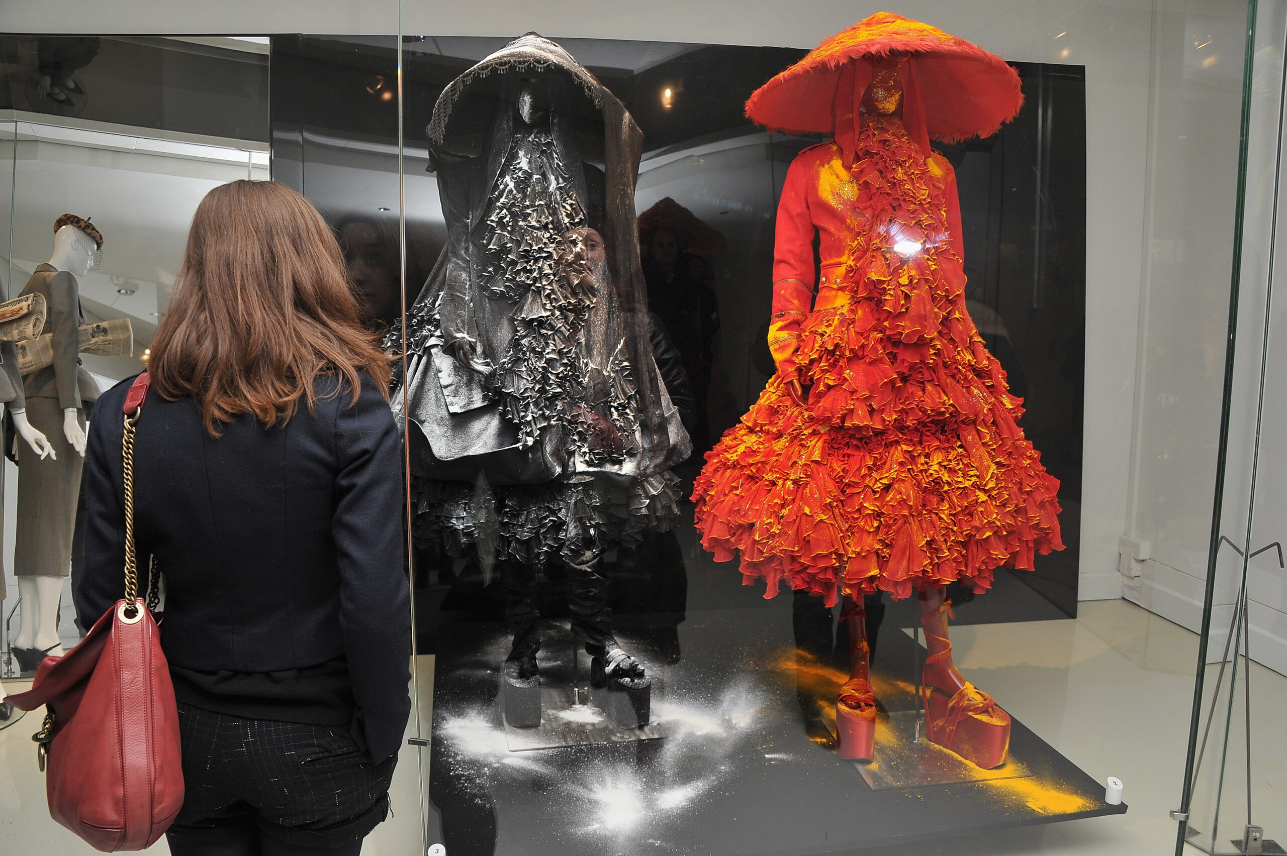 PARIS - NOVEMBER 24: A Visitor looks at Christian Dior dresses designed by John Galiano are displayed at Musee Des Arts Decoratifs on November 24, 2010 in Paris, France. (Photo by Pascal Le Segretain/Getty Images for Reebok)