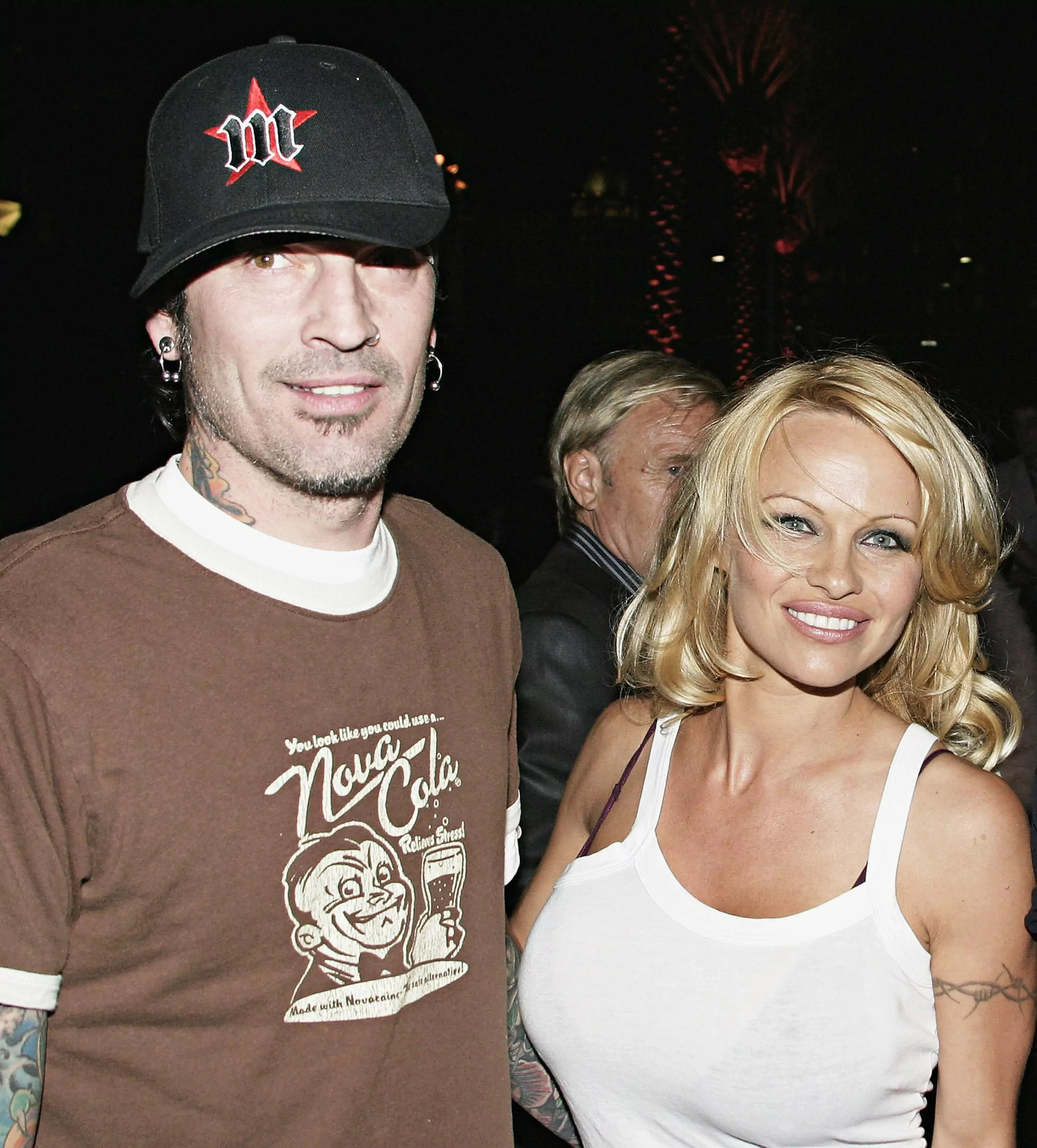 BEVERLY HILLS, CA - MARCH 28: Pamela Anderson and Tommy Lee arrive at the Rodeo Drive Walk of Style Event Honoring Tom Ford on March 28, 2004 in Beverly Hills, California. (Photo by Giulio Marcocchi/Getty Images)